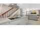 Open-concept kitchen features marble counters, modern appliances, breakfast bar, and a view of the living space at 6836 Midnight Pass Rd # 6836, Sarasota, FL 34242