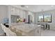 Bright kitchen featuring marble countertops, modern appliances, stylish cabinets, and a breakfast bar at 6836 Midnight Pass Rd # 6836, Sarasota, FL 34242