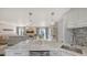 Open floor plan showcases kitchen with marble counters and view to the living area with modern furnishings at 6836 Midnight Pass Rd # 6836, Sarasota, FL 34242