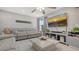 Open-concept living room with tiled floors, a ceiling fan, and a large flat screen TV at 6836 Midnight Pass Rd # 6836, Sarasota, FL 34242