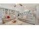 Bright living room showcasing built-in shelves, comfortable seating, and access to a screened in patio at 6836 Midnight Pass Rd # 6836, Sarasota, FL 34242