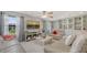 Bright living room featuring comfortable sofas, a ceiling fan, and a large window offering neighborhood views at 6836 Midnight Pass Rd # 6836, Sarasota, FL 34242