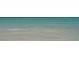 Tranquil ocean waters with clear visibility near the sandy shoreline at 6836 Midnight Pass Rd # 6836, Sarasota, FL 34242