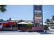 Exterior shot of a colorful outdoor bar and restaurant in a tropical setting at 6836 Midnight Pass Rd # 6836, Sarasota, FL 34242