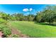 Beautiful backyard with lush green grass and mature trees at 6907 Grand Estuary Trl # 104, Bradenton, FL 34212