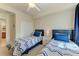 This bedroom features two twin beds and a ceiling fan at 6907 Grand Estuary Trl # 104, Bradenton, FL 34212