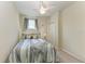 This charming bedroom features a ceiling fan and a cozy bed at 6907 Grand Estuary Trl # 104, Bradenton, FL 34212