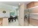 Open-concept area view with dining room set, breakfast bar, and stainless refrigerator at 6907 Grand Estuary Trl # 104, Bradenton, FL 34212