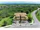 Expansive condo featuring a well-maintained lawn, lush trees, and beautiful landscaping at 6907 Grand Estuary Trl # 104, Bradenton, FL 34212