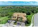 Stunning condo showcasing well-maintained landscaping, mature palms, and paver driveway at 6907 Grand Estuary Trl # 104, Bradenton, FL 34212