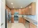 Updated kitchen with stainless steel appliances, granite counters, and tiled backsplash at 6907 Grand Estuary Trl # 104, Bradenton, FL 34212