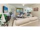Inviting living area with access to the patio, offering natural light and a seamless indoor-outdoor transition at 6907 Grand Estuary Trl # 104, Bradenton, FL 34212