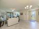 Bright and airy living room featuring neutral colors, tile floors, and a seamless flow to the outdoors at 6907 Grand Estuary Trl # 104, Bradenton, FL 34212