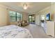Large main bedroom includes lanai access, sitting area, and doorway to ensuite bathroom at 6907 Grand Estuary Trl # 104, Bradenton, FL 34212