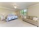 Spacious main bedroom with ample natural light, a sitting area, and neutral decor at 6907 Grand Estuary Trl # 104, Bradenton, FL 34212