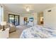 Bright main bedroom with sitting area, dresser, and private access to screened-in lanai at 6907 Grand Estuary Trl # 104, Bradenton, FL 34212