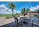 Outdoor patio featuring comfortable seating, mature palm trees, and an amazing view of the golf course at 6907 Grand Estuary Trl # 104, Bradenton, FL 34212
