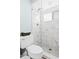 Contemporary bathroom with glass-enclosed shower, toilet, and marble-patterned tile work at 6909 34Th W Ave, Bradenton, FL 34209