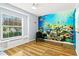 Charming bedroom with a large window, decorative ocean mural, and wood flooring at 6909 34Th W Ave, Bradenton, FL 34209