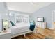 Bright bedroom featuring light blue walls, white furniture, and sliding glass doors to a patio at 6909 34Th W Ave, Bradenton, FL 34209