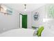 Inviting bedroom with beach-themed decor, green door, and modern furniture at 6909 34Th W Ave, Bradenton, FL 34209