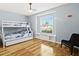 Cozy bedroom with bunk beds, natural light, and laminate wood flooring at 6909 34Th W Ave, Bradenton, FL 34209