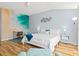 Bright bedroom featuring a beach mural, white furniture, and stylish decor creating a tranquil coastal vibe at 6909 34Th W Ave, Bradenton, FL 34209