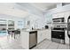 Eat-in kitchen with white cabinets, stainless appliances, tile floors and views of a pool at 6909 34Th W Ave, Bradenton, FL 34209