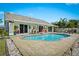 Backyard oasis features a sparkling pool, brick patio, and a privacy fence at 6909 34Th W Ave, Bradenton, FL 34209