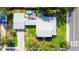 Aerial view of a property highlighting a well-maintained roof, lush backyard, and outdoor entertaining space at 708 32Nd W St, Bradenton, FL 34205