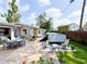 Inviting backyard featuring a patio area with outdoor dining and seating, a spa, and lush landscaping at 708 32Nd W St, Bradenton, FL 34205