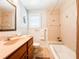 Cozy bathroom features tiled walls, a shower/tub combo, and a wooden vanity at 708 32Nd W St, Bradenton, FL 34205