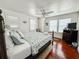 Bright bedroom featuring hardwood floors, a ceiling fan, and a comfortable-looking bed at 708 32Nd W St, Bradenton, FL 34205