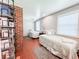 Comfortable bedroom with two twin beds, red-tiled floors, and a bookshelf at 708 32Nd W St, Bradenton, FL 34205