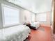 Bright bedroom featuring two twin beds, neutral paint, large windows, and brick flooring at 708 32Nd W St, Bradenton, FL 34205
