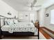 Bright bedroom featuring hardwood floors, a ceiling fan, and a comfortable-looking bed at 708 32Nd W St, Bradenton, FL 34205