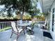 A spacious deck features patio furniture and shade from mature trees at 708 32Nd W St, Bradenton, FL 34205