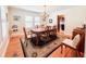 Elegant dining room featuring hardwood floors, a classic chandelier, and a large window that brings in natural light at 708 32Nd W St, Bradenton, FL 34205