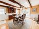 Bright dining room with exposed beams and a door to the back patio, perfect for entertaining Gathering and friends at 708 32Nd W St, Bradenton, FL 34205