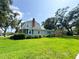 Charming two-story home with a well-maintained lawn and mature trees and shrubs at 708 32Nd W St, Bradenton, FL 34205
