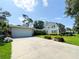 Beautiful two-story home with a large driveway, well-maintained lawn, and landscaped flower beds showcasing the lovely curb appeal at 708 32Nd W St, Bradenton, FL 34205