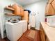 A laundry room featuring a washer and dryer, tile floors, and plenty of storage at 708 32Nd W St, Bradenton, FL 34205