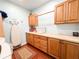 A laundry room featuring tile floors, plenty of storage, and a countertop folding area at 708 32Nd W St, Bradenton, FL 34205