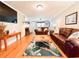 Inviting living room with hardwood floors, a fireplace, and comfortable leather furniture at 708 32Nd W St, Bradenton, FL 34205