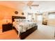 Bright primary bedroom with a king bed, ceiling fans, and large windows at 708 32Nd W St, Bradenton, FL 34205