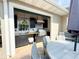 Outdoor kitchen boasts a built-in sink, countertop, and stainless steel grill under a covered lanai at 708 32Nd W St, Bradenton, FL 34205