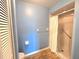 Bathroom features blue walls, toilet, wooden floors, and tile shower at 7201 29Th Avenue W Dr # 306, Bradenton, FL 34209