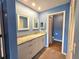 Bathroom features blue walls, double mirrors, large vanity, and access to the toilet and shower at 7201 29Th Avenue W Dr # 306, Bradenton, FL 34209