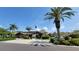 A community building featuring an American flag with surrounding lush landscaping and ample parking at 7201 29Th Avenue W Dr # 306, Bradenton, FL 34209