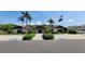Community building featuring an American flag and palm trees, with accessible parking in front at 7201 29Th Avenue W Dr # 306, Bradenton, FL 34209